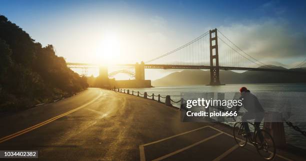 commuter with road racing bicycle and golden gate bridge - golden gate park stock pictures, royalty-free photos & images