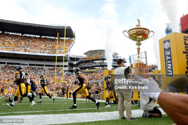 The Ryder Cup is displayed as members of the Pittsburgh Steelers run onto the field prior to the start of the game against the Kansas City Chiefes at...