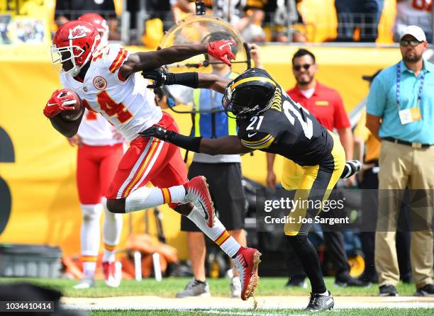 Sammy Watkins of the Kansas City Chiefs runs upfield after a catch as Sean Davis of the Pittsburgh Steelers attempts a tackle in the first quarter...