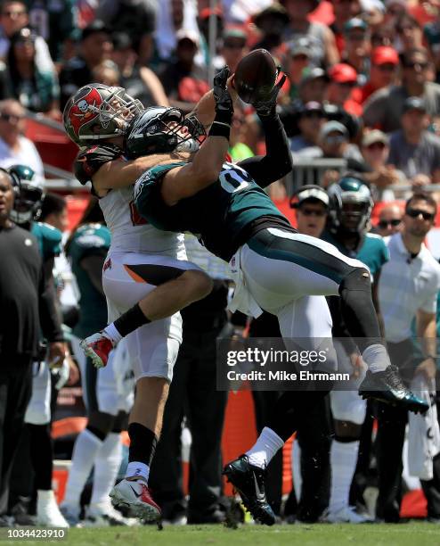 Zach Ertz of the Philadelphia Eagles is held on a catch attempt by Chris Conte of the Tampa Bay Buccaneers during a game at Raymond James Stadium on...