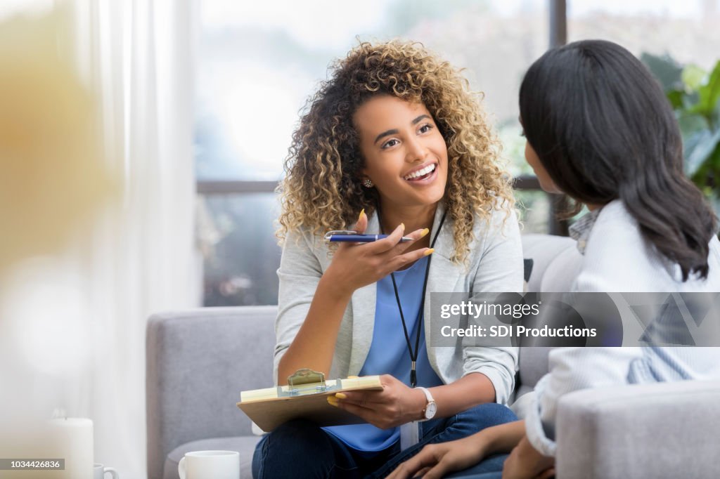 Encouraging therapist talks with young woman