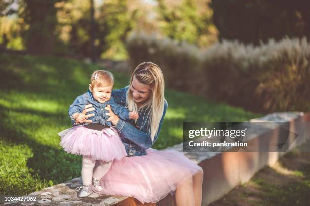 glückliche mutter mit ihrer kleinen tochter beide bekleidet tutu - identische kleidung stock-fotos und bilder