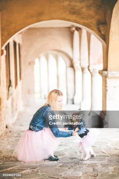 happy mother with her little daughter both dressed in tutu - gorizia stock pictures, royalty-free photos & images