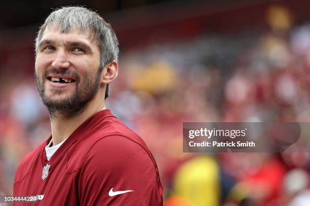 Alex Ovechkin of the Washington Capitals NHL hockey team looks on from the sideline before the Indianapolis Colts play the Washington Redskins at...