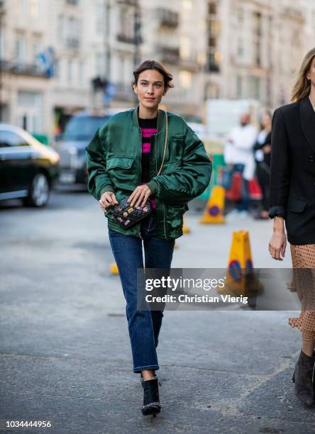 Alexa Chung wearing green bomber jacket, cropped denim jeans seen outside Simone Rocha during London Fashion Week September 2018 on September 16,...