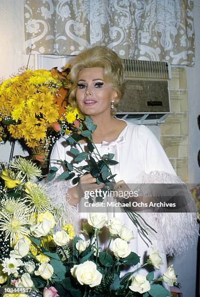 Actress Zsa Zsa Gabor poses with flowers in her dressing room after her opening night performance at the Huntington Hartford Theater on October 27,...