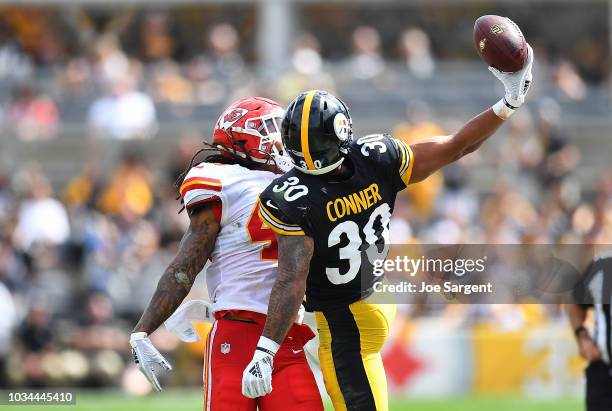 James Conner of the Pittsburgh Steelers makes a one handed catch as Terrance Smith of the Kansas City Chiefs defends in the first half during the...