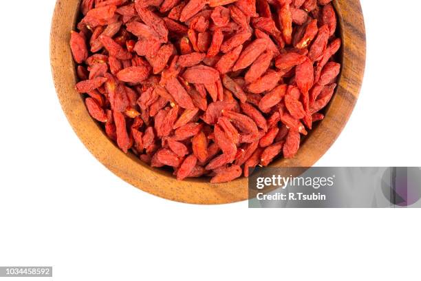 chinese goji berries in wooden bowl close up on white background - wolfberry stock pictures, royalty-free photos & images