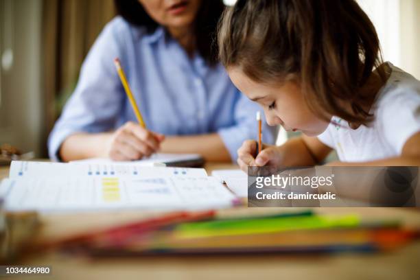 mother helping daughter with homework - coach stock pictures, royalty-free photos & images