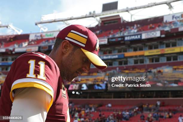 Quarterback Alex Smith of the Washington Redskins walks off of the field after losing to the Indianapolis Colts at FedExField on September 16, 2018...
