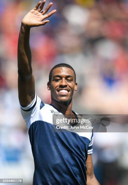 Los Angeles Rams cheerleader Quinton Peron, one of the first male NFL cheerleaders, waves ahead of the game against the Arizona Cardinals at Los...