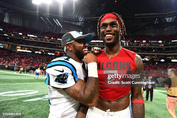 Julio Jones of the Atlanta Falcons talks with Captain Munnerlyn of the Carolina Panthers after the game at Mercedes-Benz Stadium on September 16,...