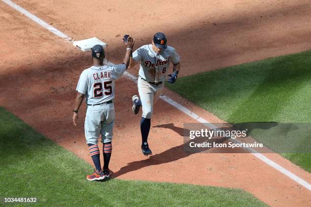 Detroit Tigers outfielder Mikie Mahtook gets a high-five from Detroit Tigers third base coach Dave Clark as he rounds the bases after hitting a home...