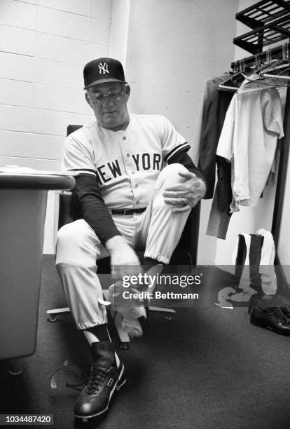 Bob Lemon, the new manager of the New York Yankees, puts on his new shoes in the visitors' locker room at the Royals Stadium.