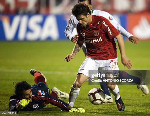 Brazil's Internacional footballer Rafael Sobis struggles for the ball with goalkeeper Luis Ernesto of Mexico's Chivas, during their Libertadores Cup...