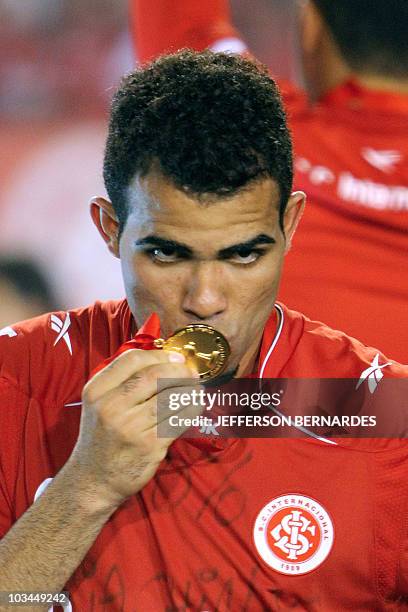 Sandro of Brazilian Internacional kisses his medal after the Libertadores Cup final football match against Mexican Chivas at Beira Rio stadium in...