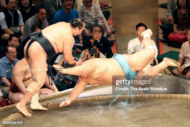 Aminishiki throws Kotoyuki to win on day eight of the Grand Sumo Autumn Tournament at Ryogoku Kokugikan on September 16, 2018 in Tokyo, Japan.