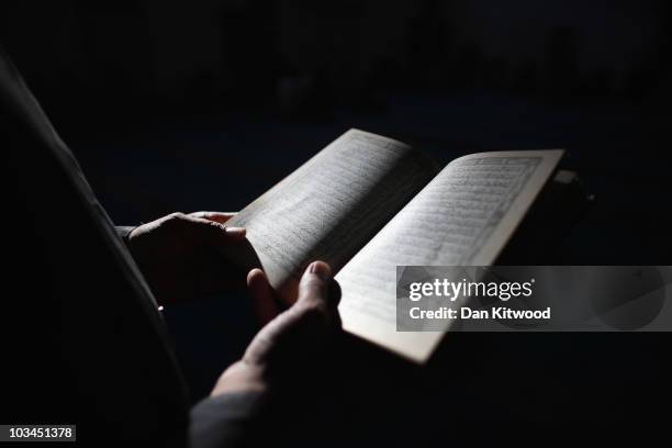 Muslim man reads the Koran before Iftar, the evening meal in the Muslim holy month of Ramadan at the London Muslim Centre on August 18, 2010 in...