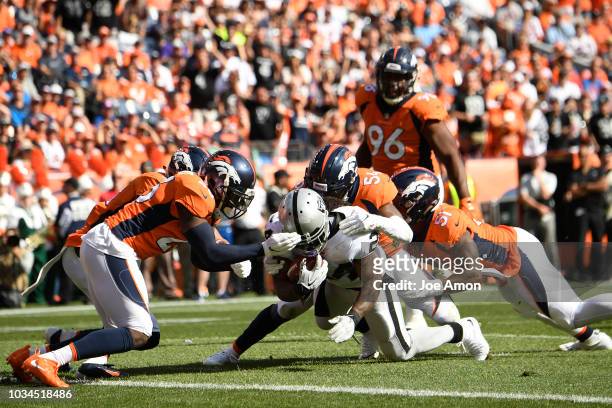 Marshawn Lynch of the Oakland Raiders catches a pass but is short of the goal line during the second quarter against the Denver Broncos. The Denver...