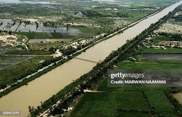 An aerial image shows water covering large stretches of land in Pakistan's southern province of Punjab on August 18, 2010. Foreign aid began flowing...