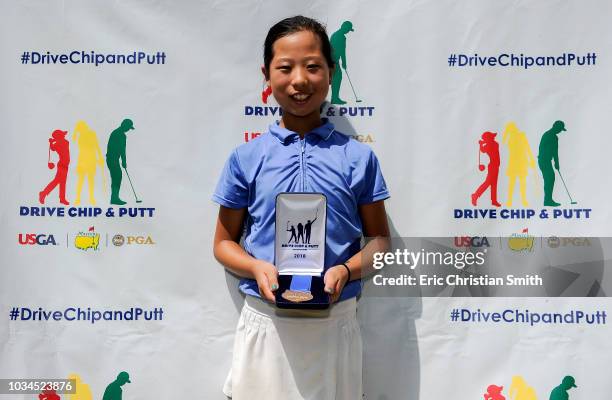 Girls 10-11 overall winner Maye Huang holds her medal during a regional round of the Drive, Chip and Putt Championship at the The Club at Carlton...