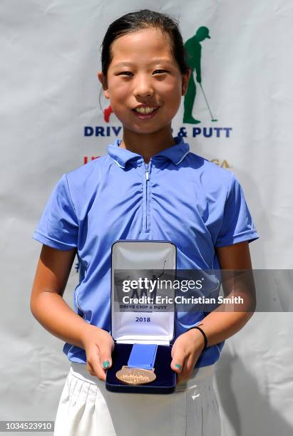 Girls 10-11 overall winner Maye Huang holds her medal during a regional round of the Drive, Chip and Putt Championship at the The Club at Carlton...