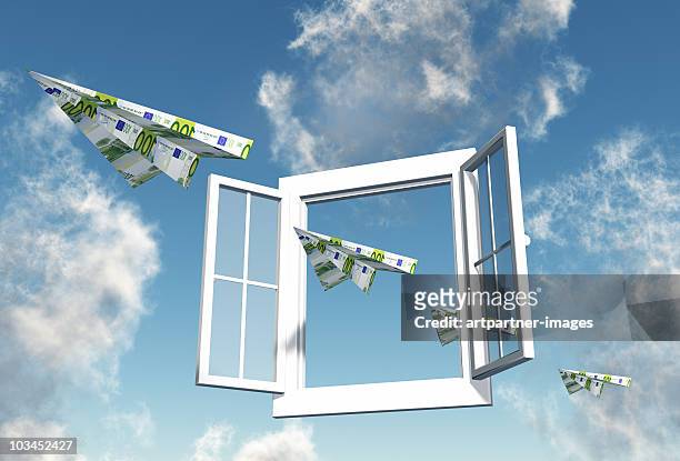 100 euro notes flying through an open window - wasting money stock pictures, royalty-free photos & images