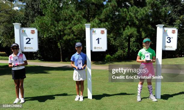 Girls 10-11 overall place finishers Khloe Yepez, Maye Huang, and Teagan Connors during a regional round of the Drive, Chip and Putt Championship at...