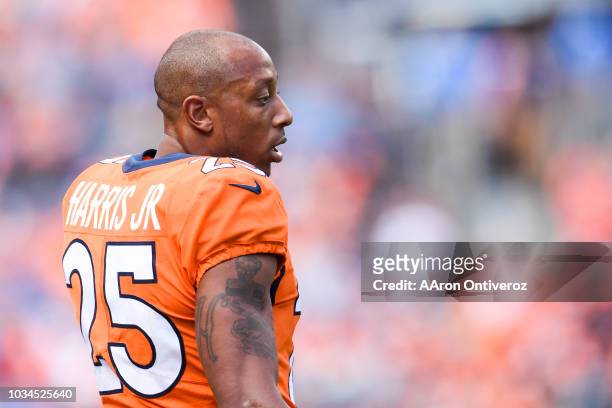 Chris Harris of the Denver Broncos stands on the field after being taken out of the game following a hit agains the Oakland Raiders during the third...