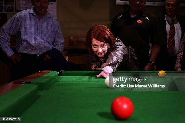 Prime Minister Julia Gillard plays pool with patrons at the Raymond Lakeside Tavern during the final week of campaigning ahead of this weekend's...