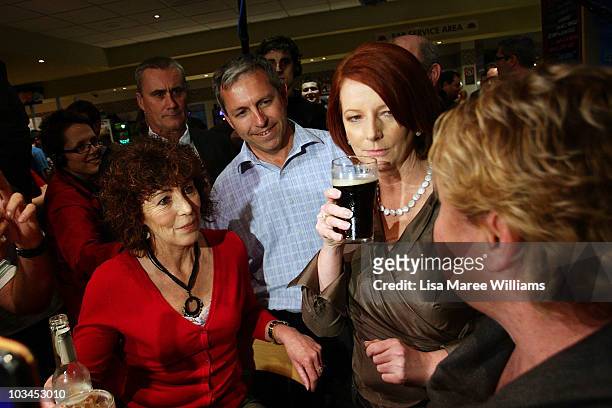 Prime Minister Julia Gillard has a drink with patrons at the Raymond Lakeside Tavern during the final week of campaigning ahead of this weekend's...