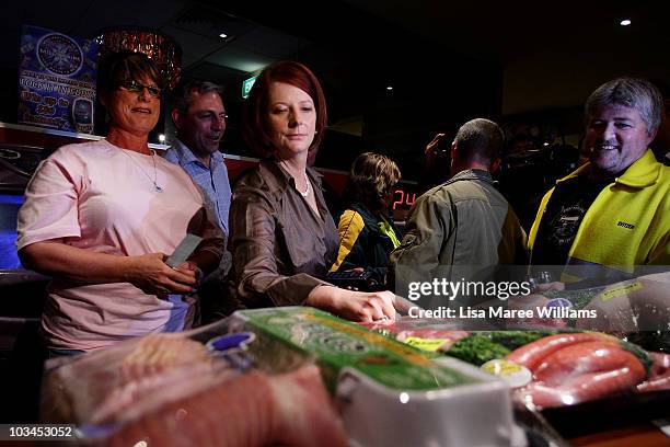 Prime Minister Julia Gillard annouces the winners of a meat tray raffle at the Raymond Lakeside Tavern during the final week of campaigning ahead of...