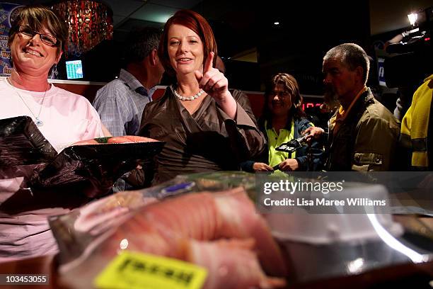 Prime Minister Julia Gillard annouces the winners of a meat tray raffle at the Raymond Lakeside Tavern during the final week of campaigning ahead of...