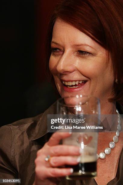 Prime Minister Julia Gillard has a drink with patrons at the Raymond Lakeside Tavern during the final week of campaigning ahead of this weekend's...