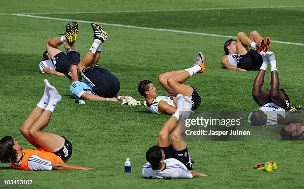 Cristiano Ronaldo of Real Madrid excercises besides his teammates at the end of a training session at the Valdebebas training ground on August 19,...