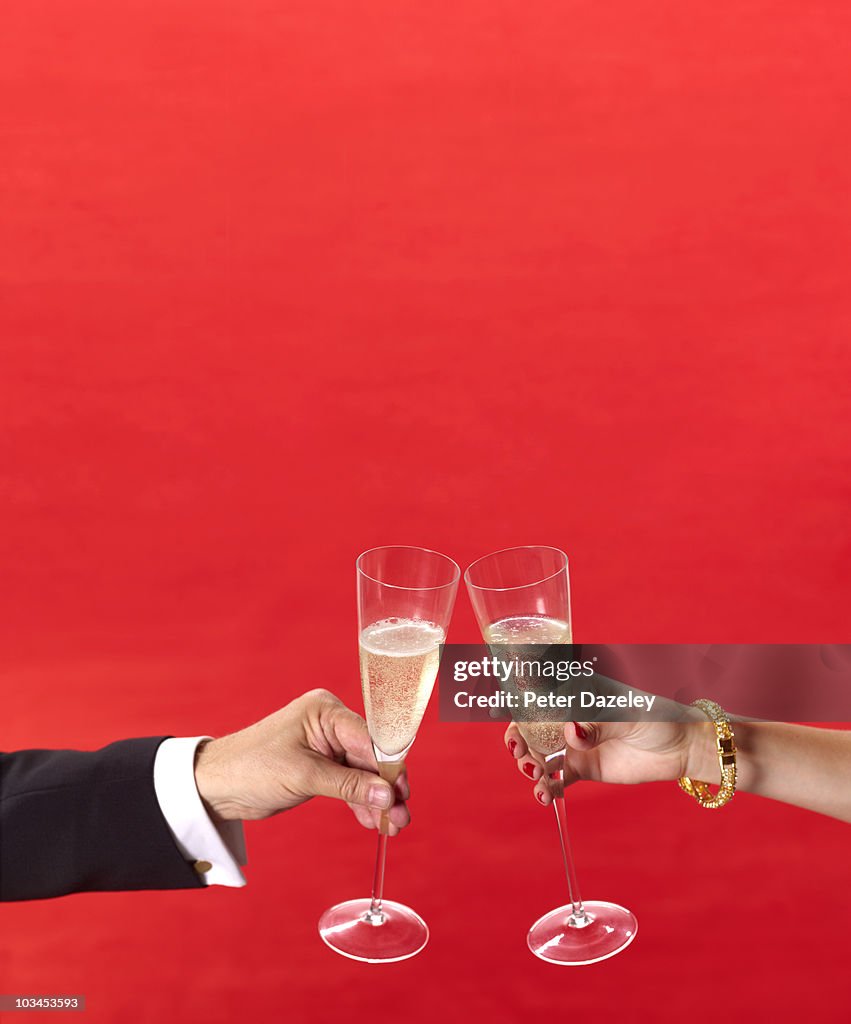 Champagne glasses toasting at red carpet event