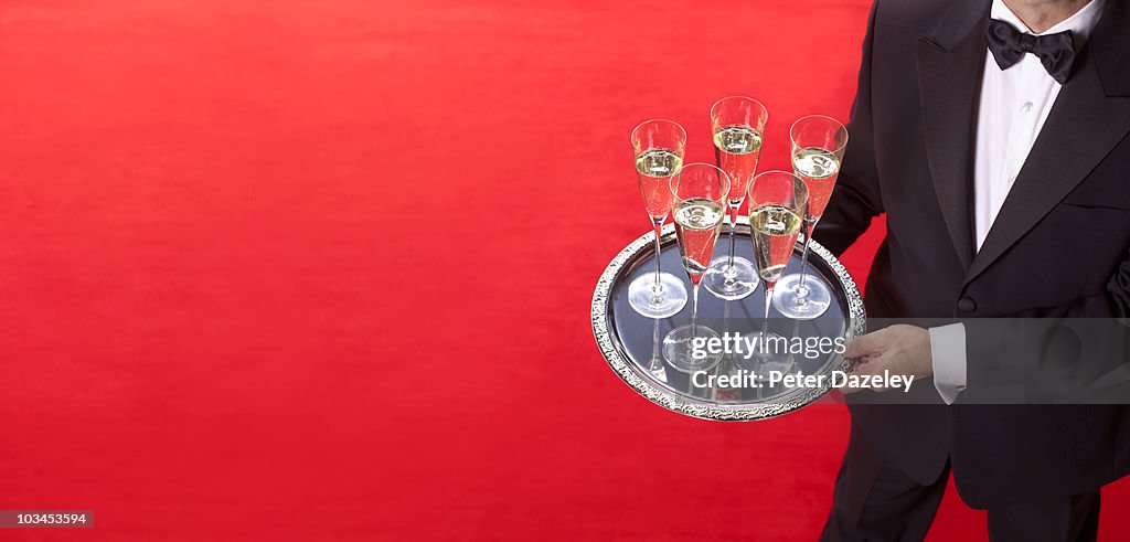 Waiter offering champagne at red carpet event