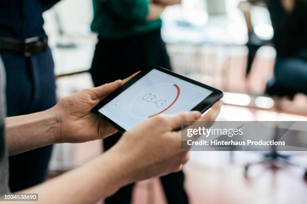 man holding timer during business meeting - man hand ipad stock pictures, royalty-free photos & images