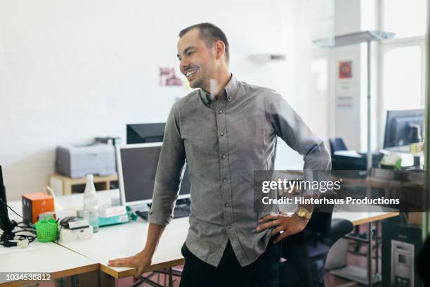 startup business office employee smiling - grey shirt ストックフォトと画像