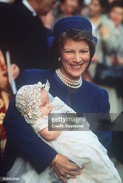 Queen Anne-Marie of Greece holds baby Princess Theodora at her christening in London, England on October 20, 1983.
