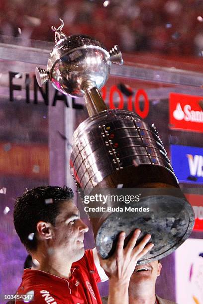 Bolivar of Internacional lift the trophy after winning the match against Mexico's Chivas Guadalajara as part of Final 2010 Copa Santander...