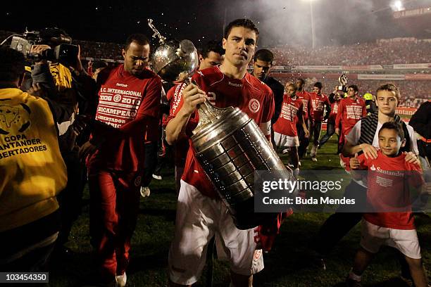 Bolivar of Internacional lift the trophy after winning the match against Mexico's Chivas Guadalajara as part of Final 2010 Copa Santander...