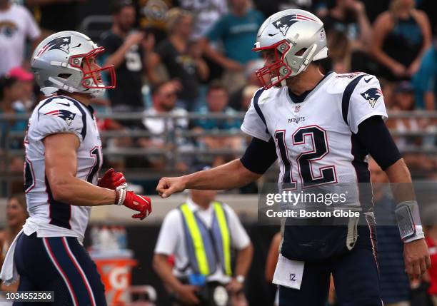New England Patriots quarterback Tom Brady and New England Patriots wide receiver Chris Hogan celebrate after Hogan's touchdown reception late in the...