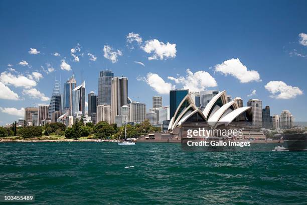 sydney opera house in sydney harbor with downtown skyline, sydney, new south wales, australia - sydney stock pictures, royalty-free photos & images