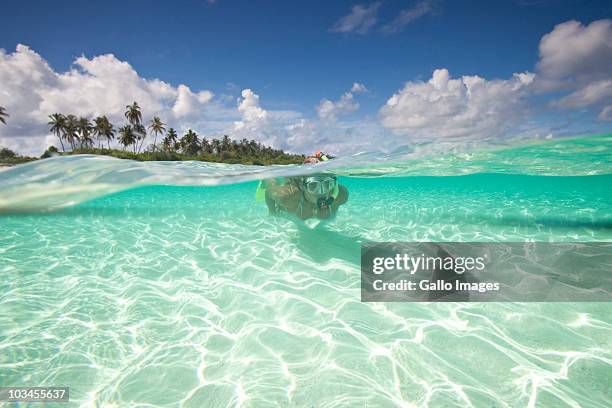 woman with mask, fins and snorkel diving in ocean, kadhdhoo island, laamu atoll, southern maldives, indian ocean - bikini atoll stockfoto's en -beelden