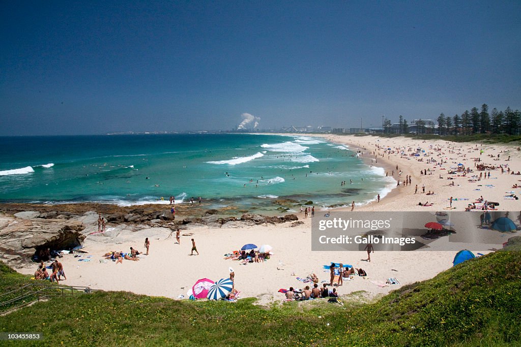 Beach with Port Kembla Industrial Area in background, Wollongong, New South Wales, Australia