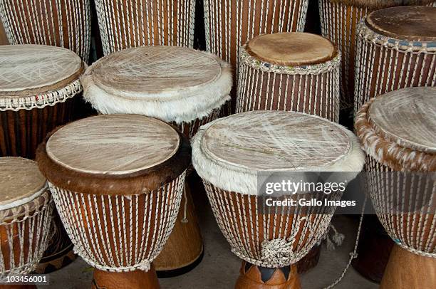 typical leather covered wooden drums, called djembe, banjul, gambia - djembe foto e immagini stock