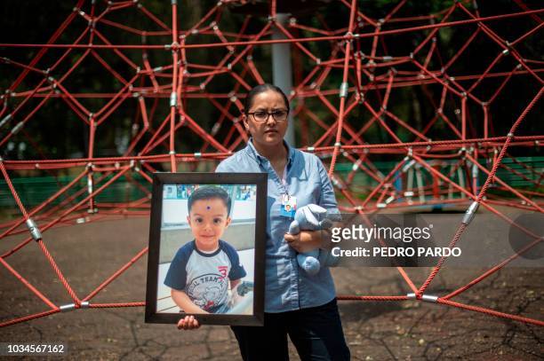 Mexican Miriam Rodriguez Guise holds the portrait of her seven-year-old son Jose Eduardo, who died in the September 19, 2017 earthquake on September...