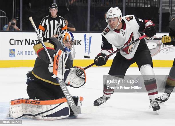 Dylan Ferguson of the Vegas Golden Knights blocks a shot in front of Christian Fischer of the Arizona Coyotes in the first period of their preseason...