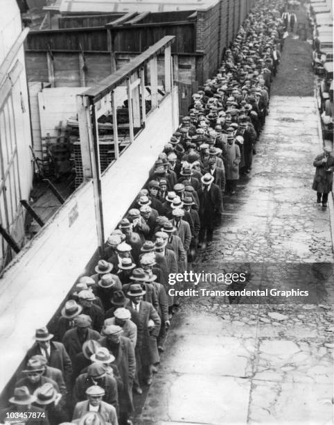 View of a long breadline for food set up during the Great Depression in New York City, 1931.